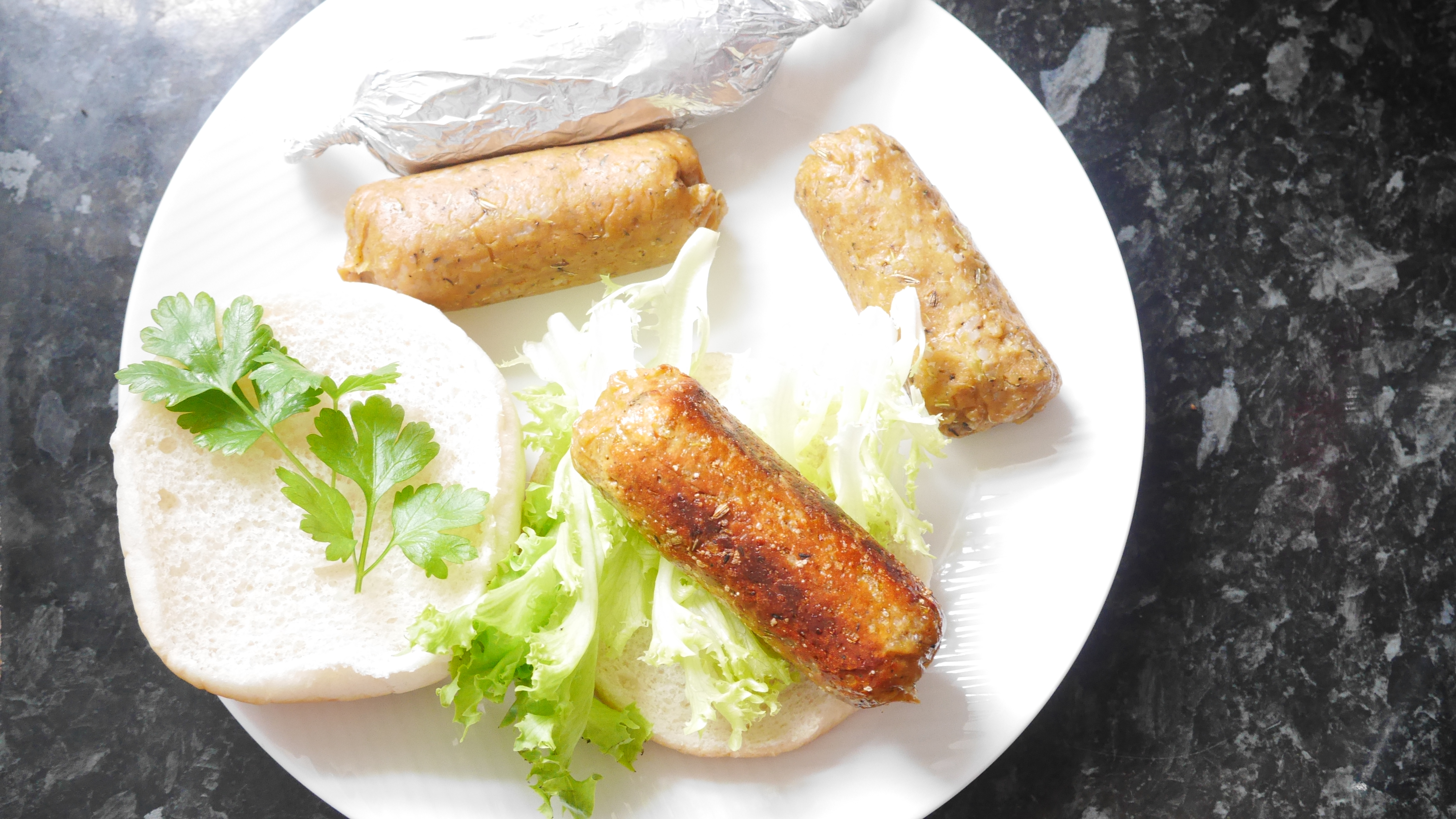 Seitan sausages on a white plate